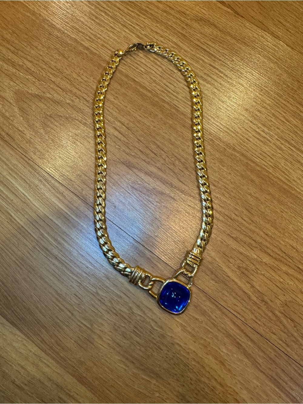 Trifari gold tone curb link necklace with blue stone bezel